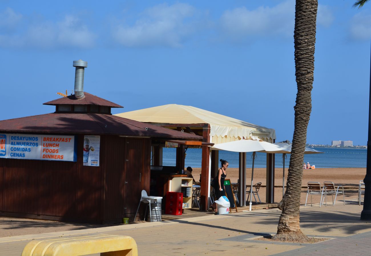 Wooden beach hut serving food and drinks with sunbeds to hire