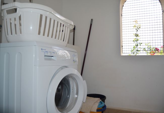 Utility room with modern electronic washing machine - Resort Choice