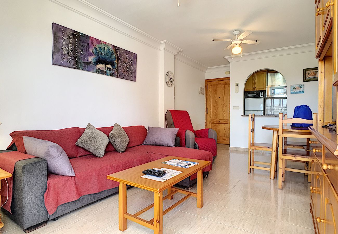 living room with sofa, dining table and chairs, tv and air conditioning